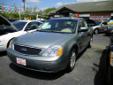 Light green 2006 Ford Five Hundred SEL is a 4 door sedan with a 6 cylinder engine, leather interior & woodgrain dash! Super Nice!