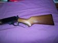 This is a Marlin Model 3083 which is a limited edition 30-30 lever action rifle made in 1993. It has a 20" barrel, blued metal, walnut wood, and a Marlin coin inlaid into the stock. It comes with the original box, has never been fired, and is in new