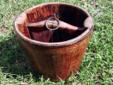 Antique Well Water Bucket
Â 
Antique wood well water bucket that appears to be from the 1930's or earlier. Sturdy construction with metal support ring well attached to bottom. Yoke is firmly secured into side structures with original rope ring still in