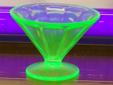 This compote or sherbert dish is made of Vaseline glass which is also known as Uranium glass. It contains a small amount of Uranium that makes it glow when illuminated near a blacklight. It measures 3" tall and 4" diameter at the rim. $15
I have a few