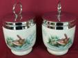 This is for a pair of Roayal Worcester egg coddlers with birds. Made of the finest porcelain. Measures 3 1/2" tall with lid. 2" in diameter. Has a ring handle on top of lid. Has a Wren carrying twigs to build her nest on one side and a pair of Finches on